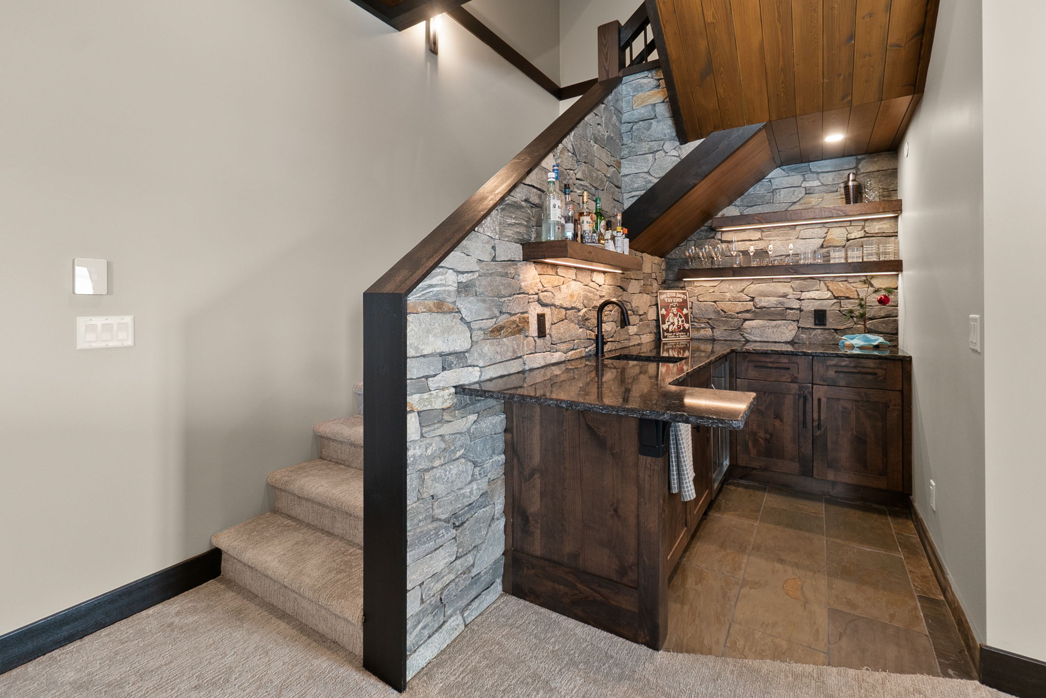 Home bar in custom build house with rustic ski chalet look - space planning under stairs